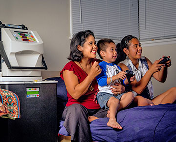 ݮƵ home dialysis patient at home watching her children play video games